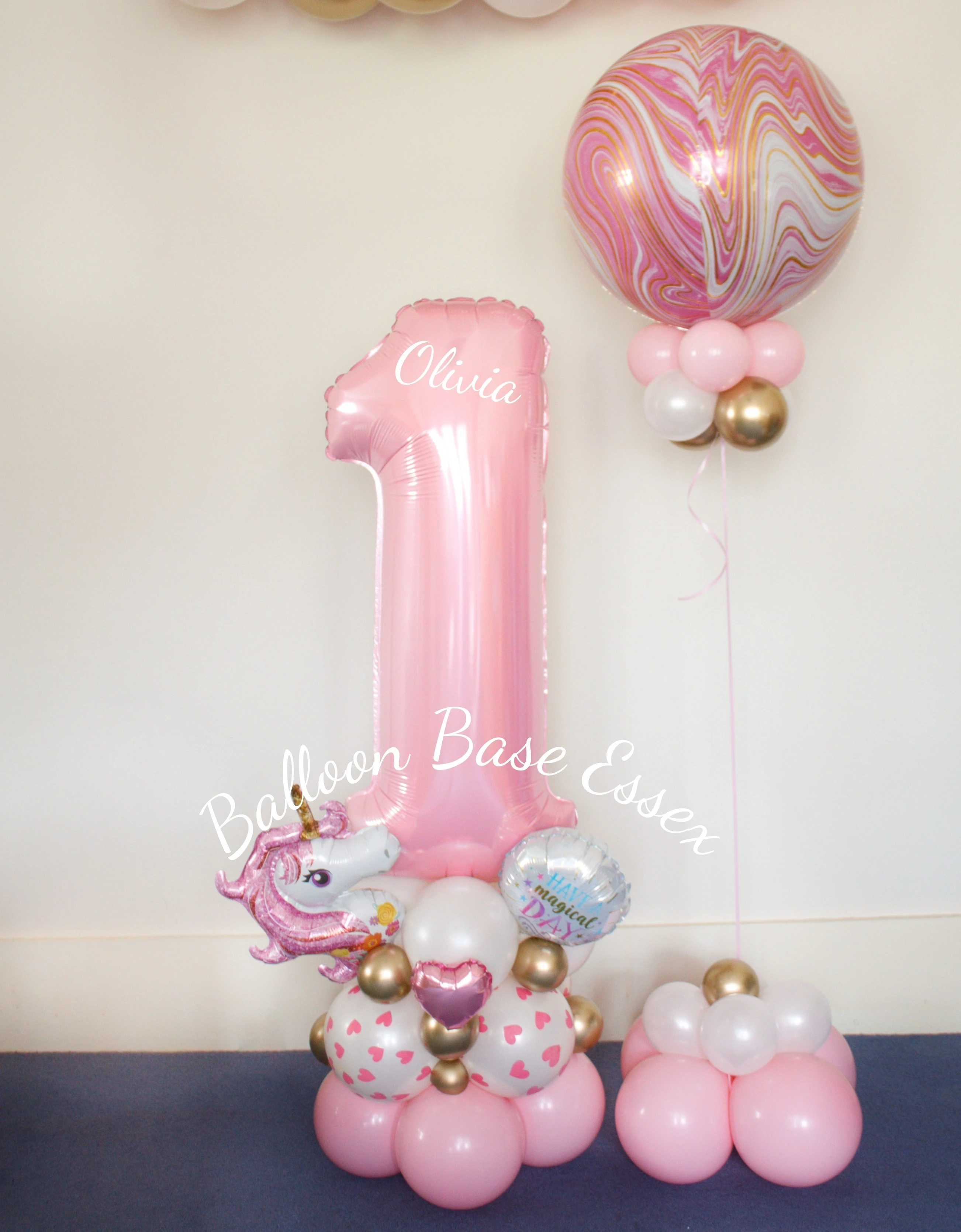 Pale pink and unicorn theme balloon stack with pink marble orbz balloon next to it
