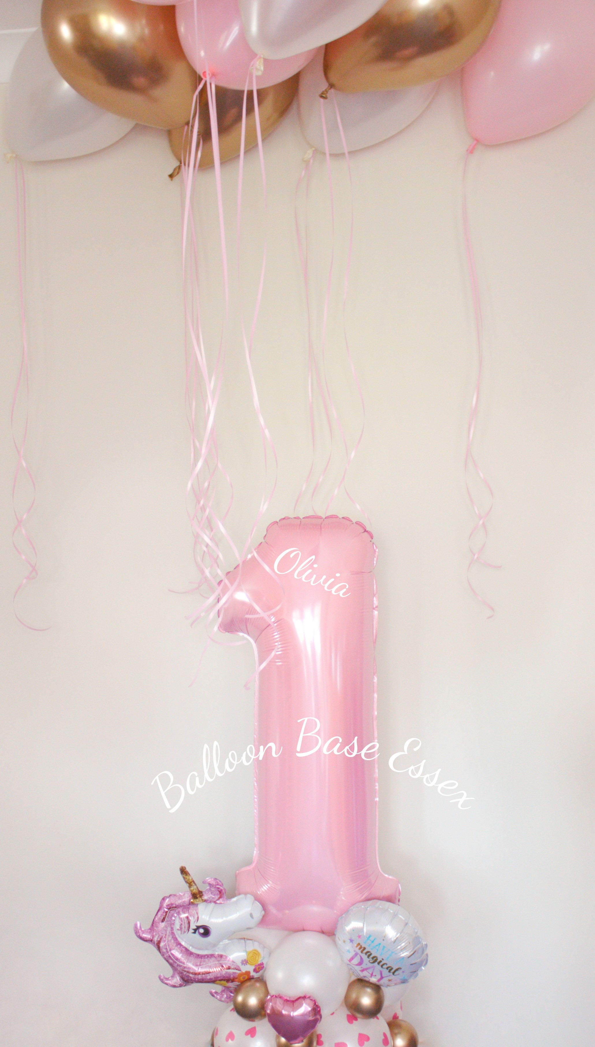 Pink number 1 balloon stack with pinke white and gold ceiling balloons above