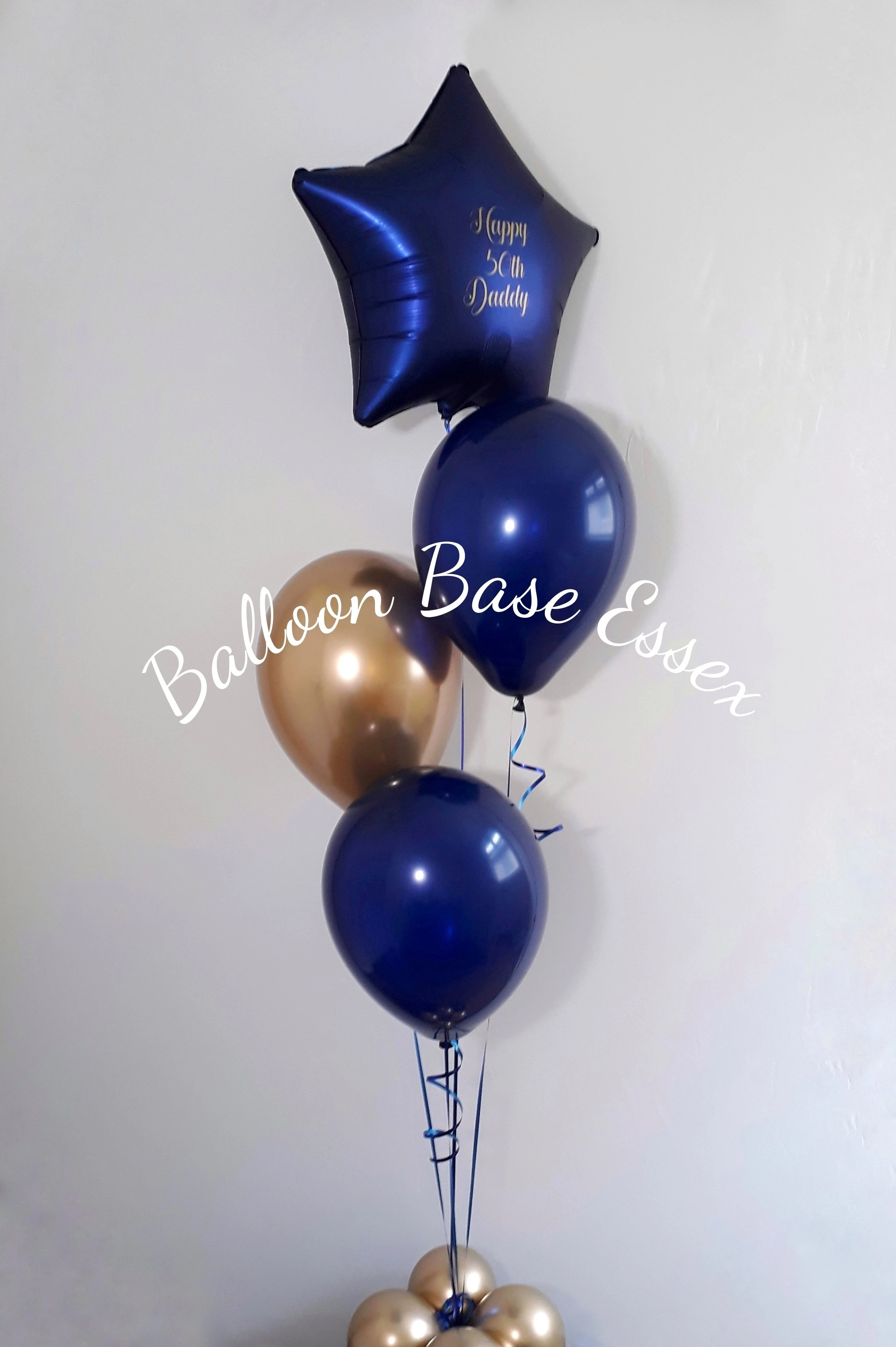 Navy and gold balloon bouquets for a 50th birthday