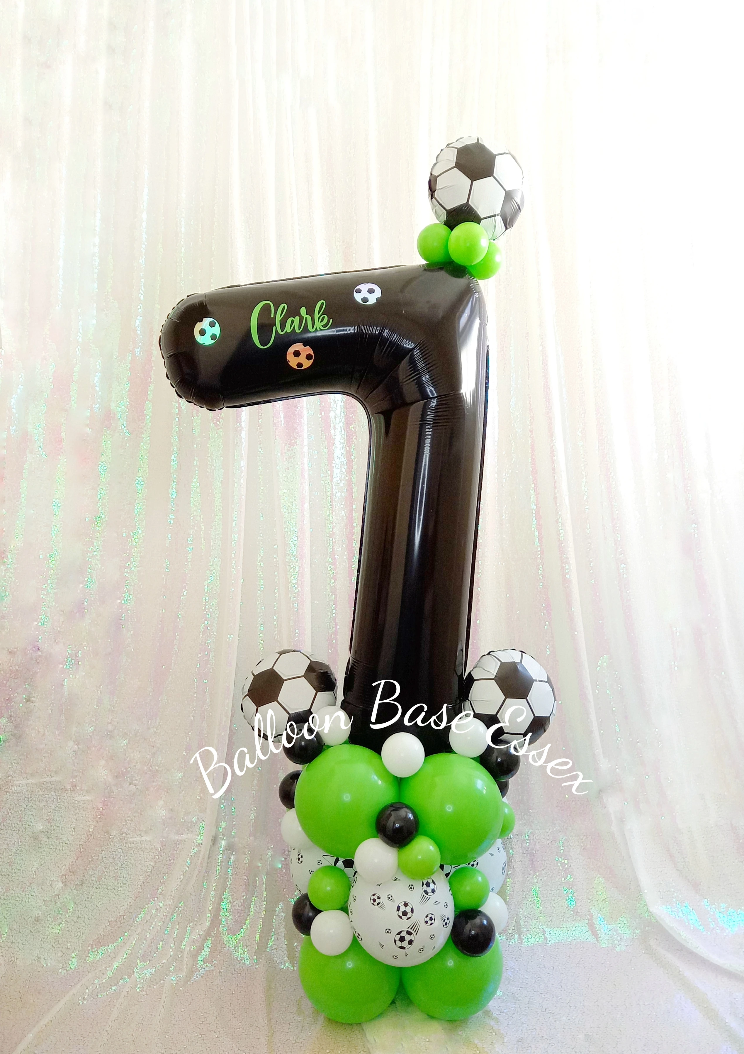 Football theme black and green number seven balloon stack