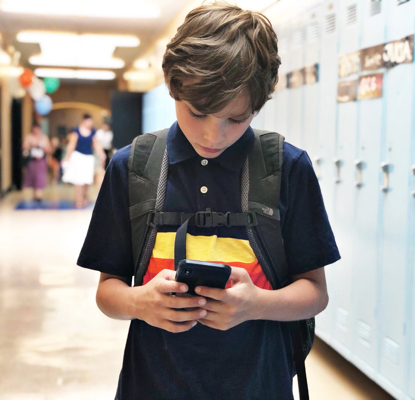 223015941536975-8th-grader-with-phone-17909493882915.jpg