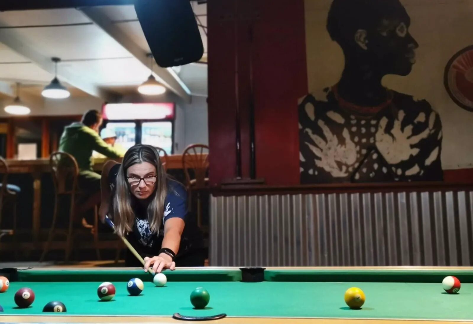 Guest playing pool in the social bar area at the retreat