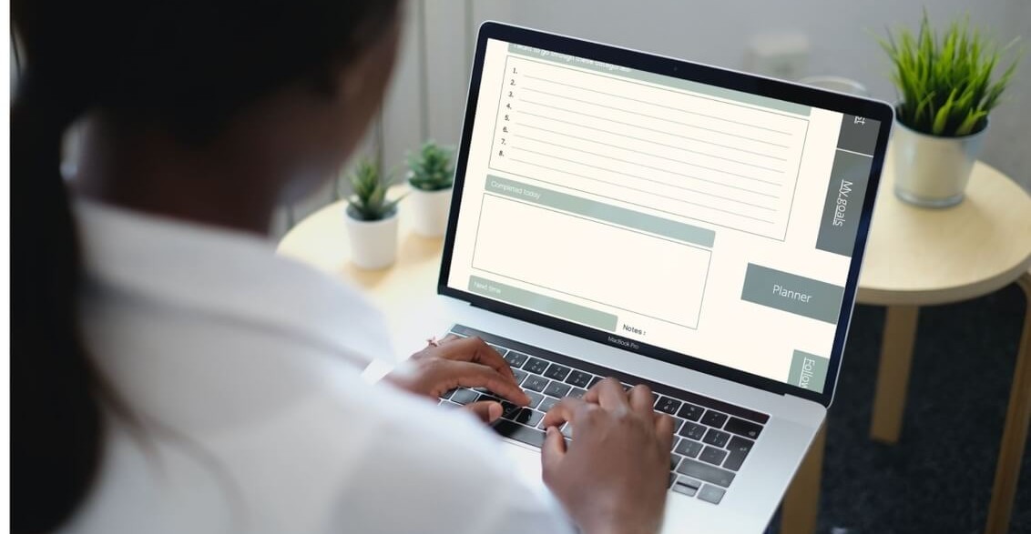 Photo of a woman working on a laptop