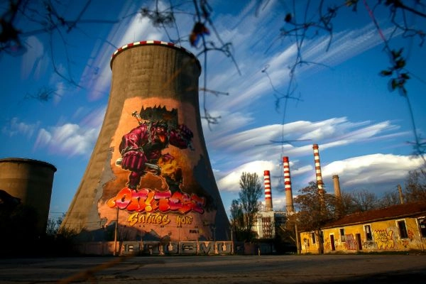 thermal power station with graffiti and expressive clouds