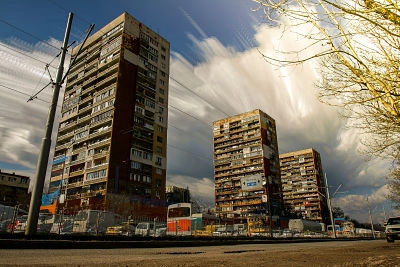 three buildings under expressive clouds