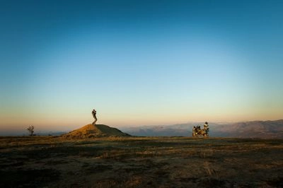 Biker and motorbike at sunset