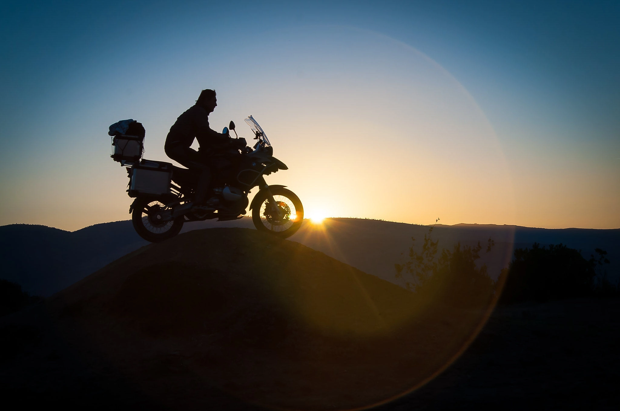 Biker riding at sunset