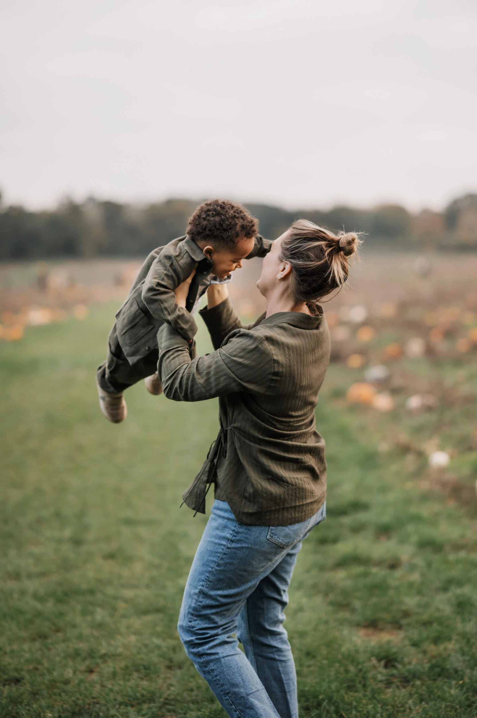 Toddler being swung in air by mum in family shoot