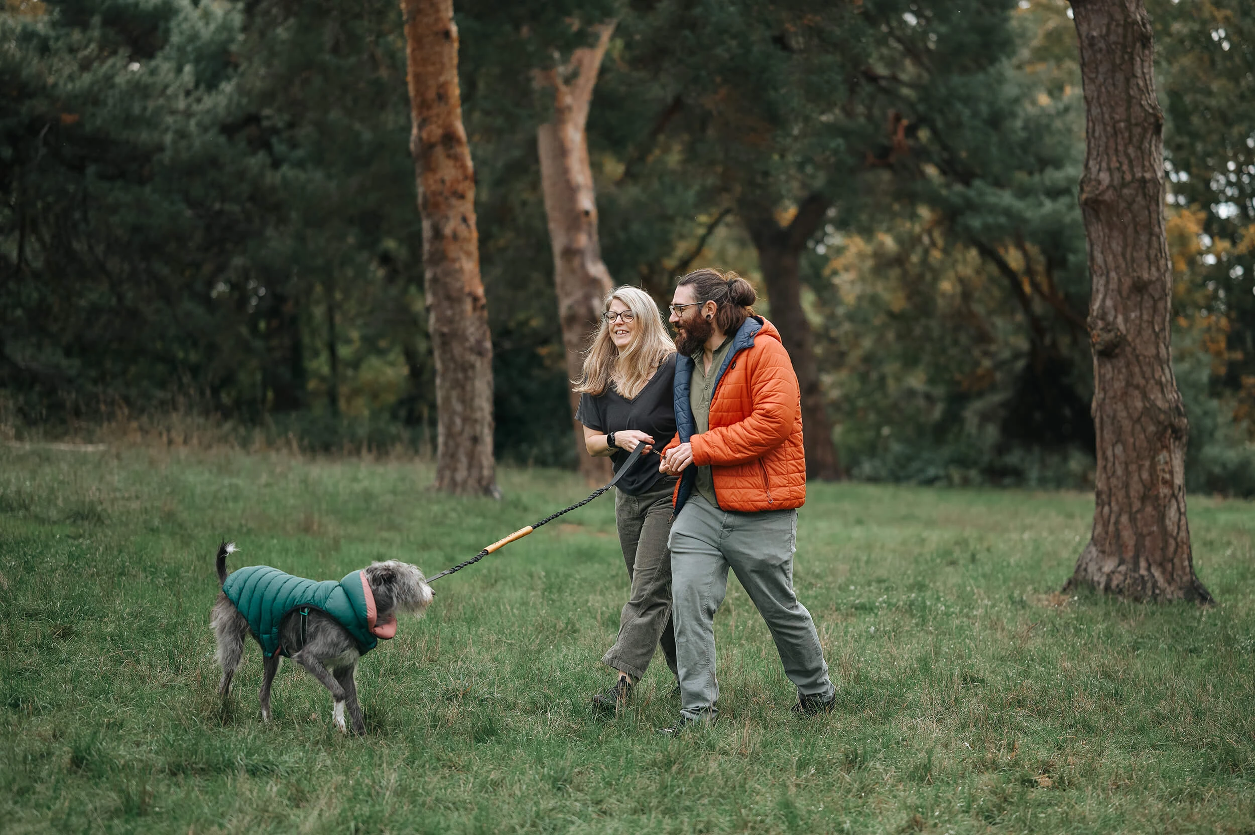 candid laughing during family photo session outdoors with dog