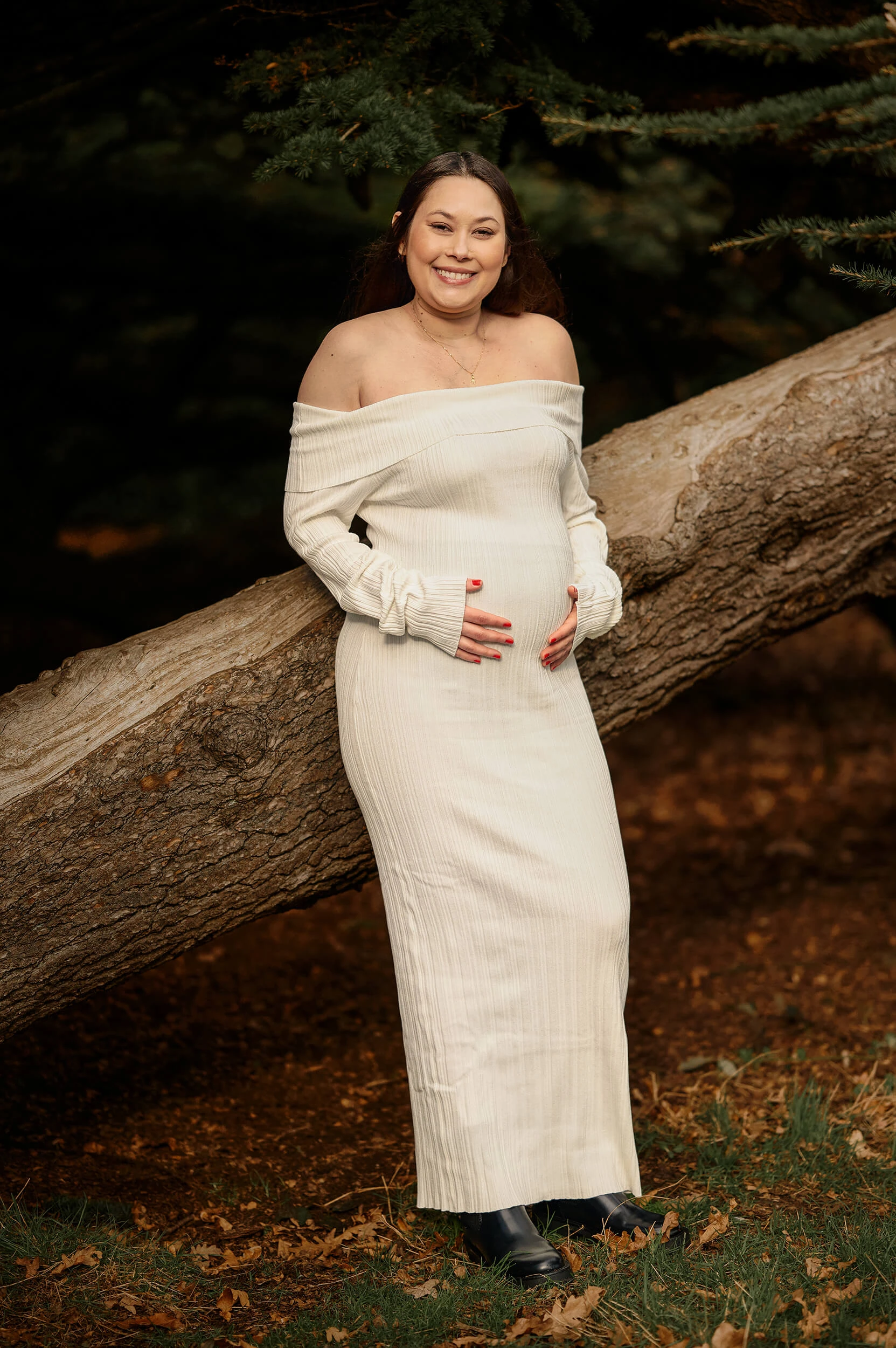 mother to be smiling for outdoors maternity photoshoot