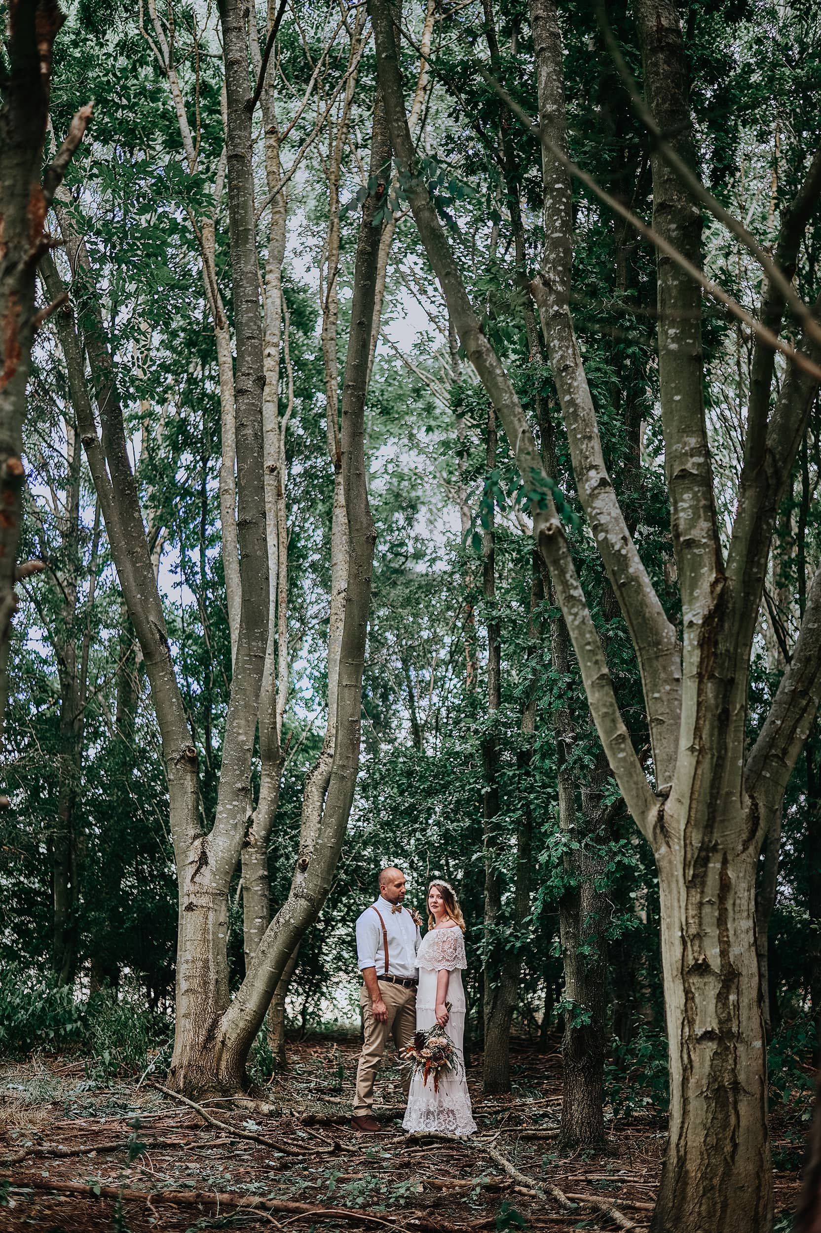 Couple in boho wedding attire at Browning Bros wedding venue for their woodland theme elopement.
