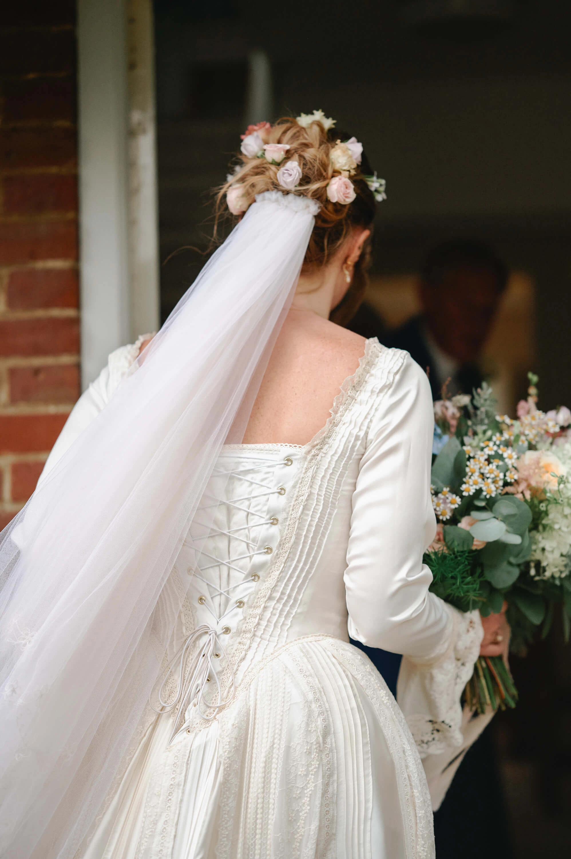 Annabelle&rsquo;s handmade wedding dress with bouquet at her family home in Canterbury