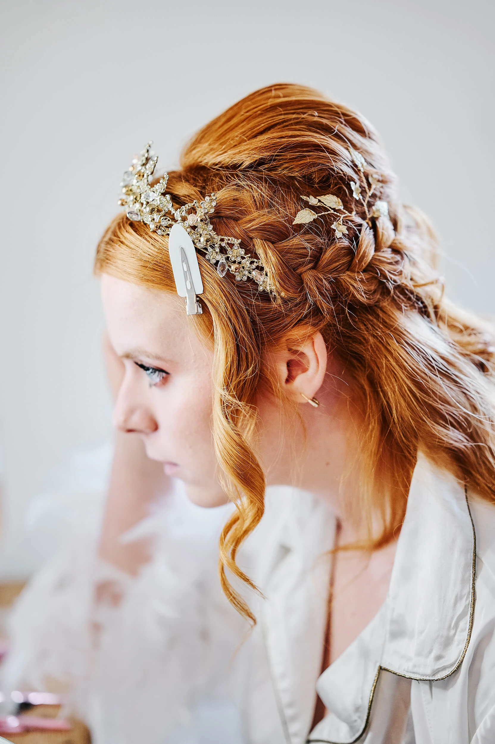 Bride getting ready at The White Hart in Great Yeldham, surrounded by her bridal party in soft natural light