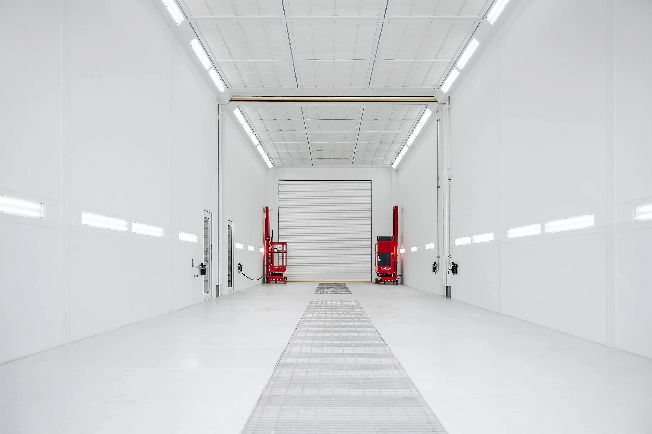 Large commercial spray booth interior designed by Junair for high-end vehicle spraying