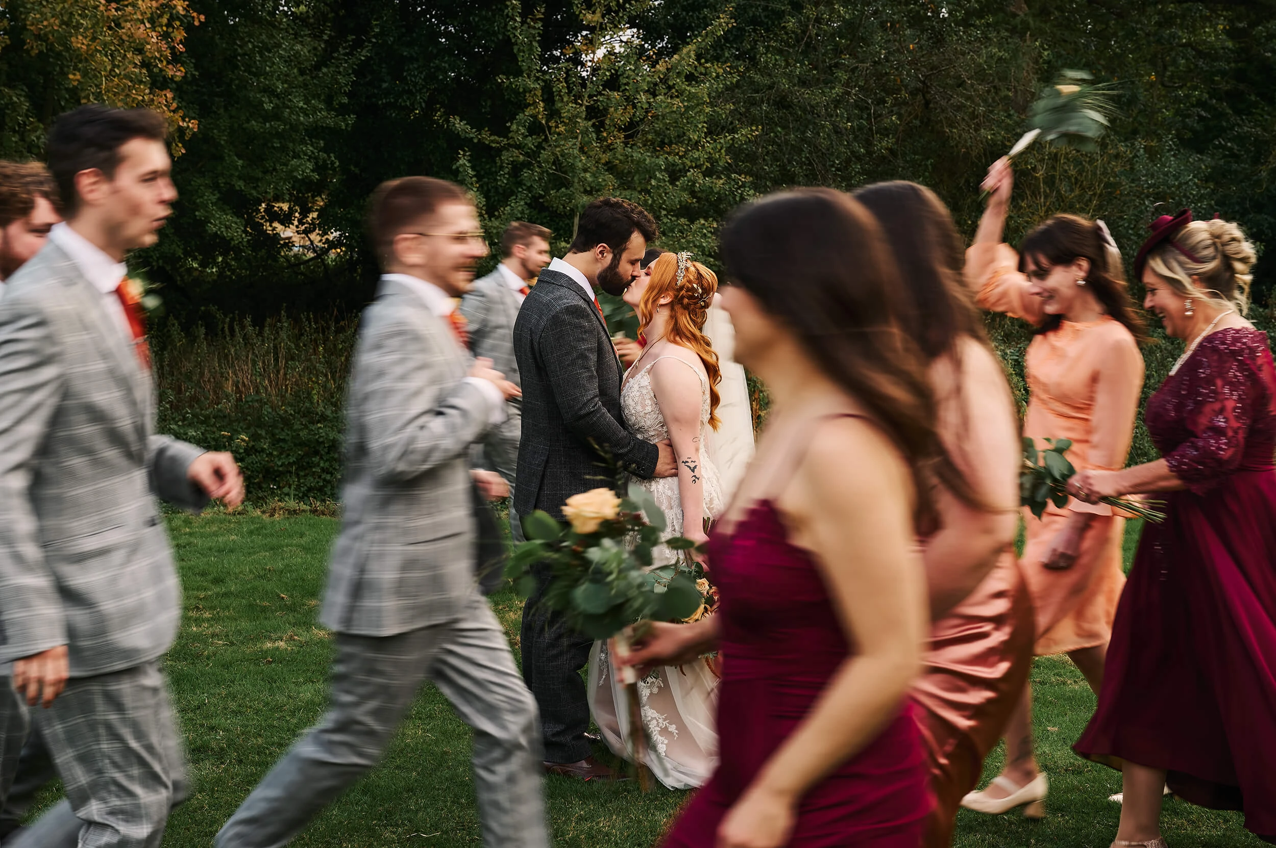 Creative bridal party group portraits at The White Hart with playful movement and laughter