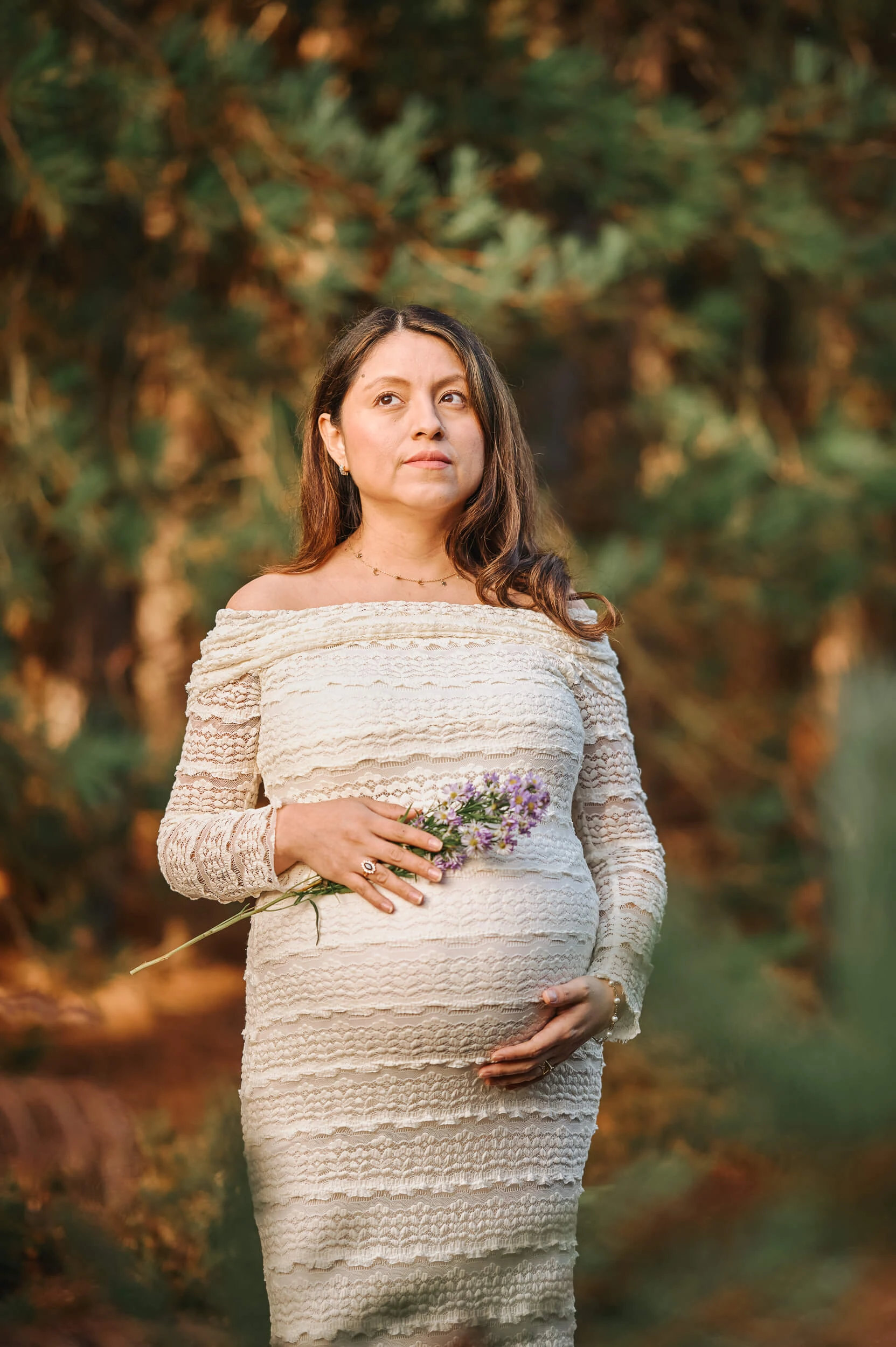 pregnancy photography outdoors in winter sun with flowers