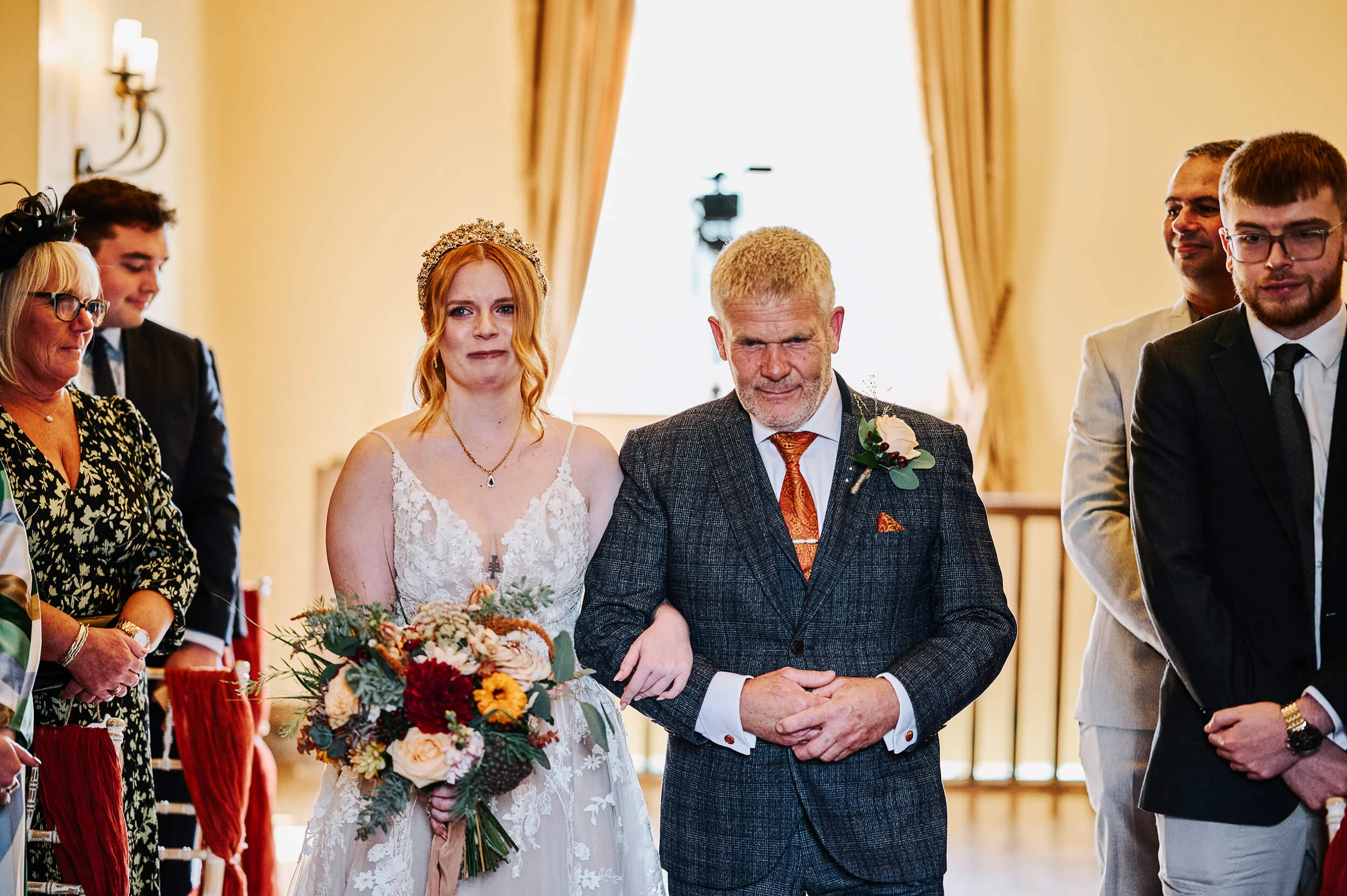 Bride walking down the aisle towards the groom during an emotional ceremony at The White Hart