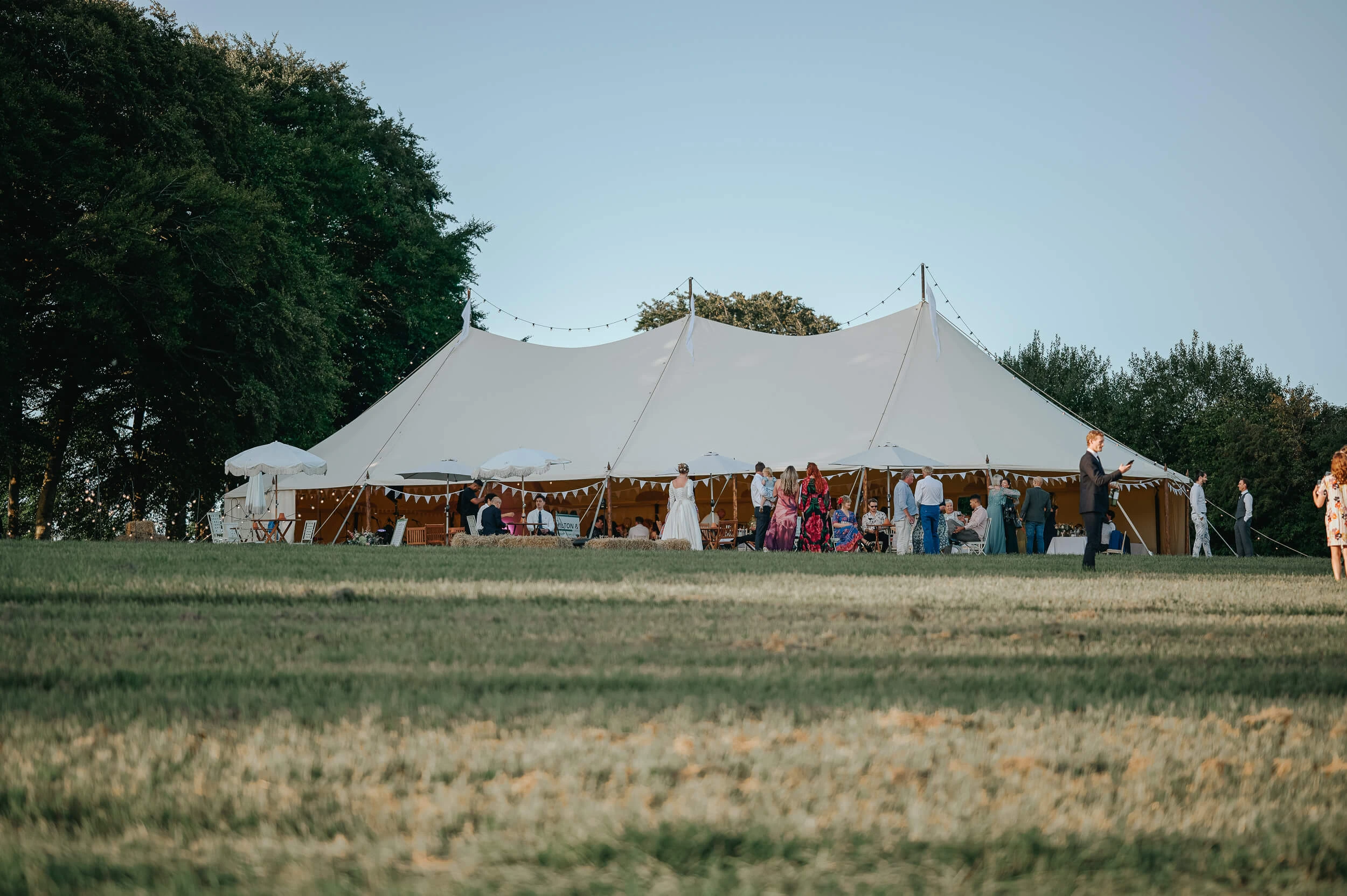 Vineyard reception setup on a hill with tables and floral d&eacute;cor in Canterbury