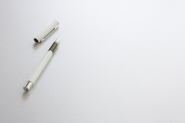 r7-a-white-pen-isolated-on-white-writing-paper-background-photo-a-white-pen-isolate.jpg