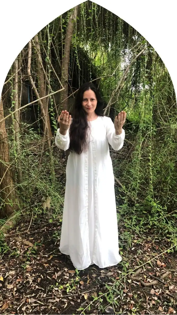Psychic Development Program – Awaken Your Intuitive Gifts Psychic Carla, a spiritual guide in white robes standing in the forest, hands extended in a sacred gesture — embodying the awakening of psychic gifts.