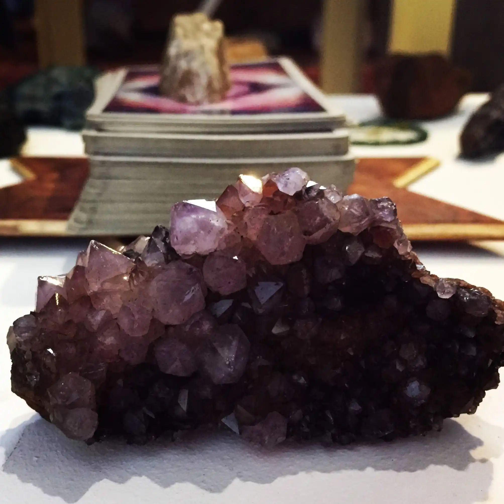 Amethyst Crystal & Tarot Deck – Psychic Readings with Carla | LunAscention Amethyst crystal with tarot deck on altar during a psychic reading session by Carla at LunAscention.