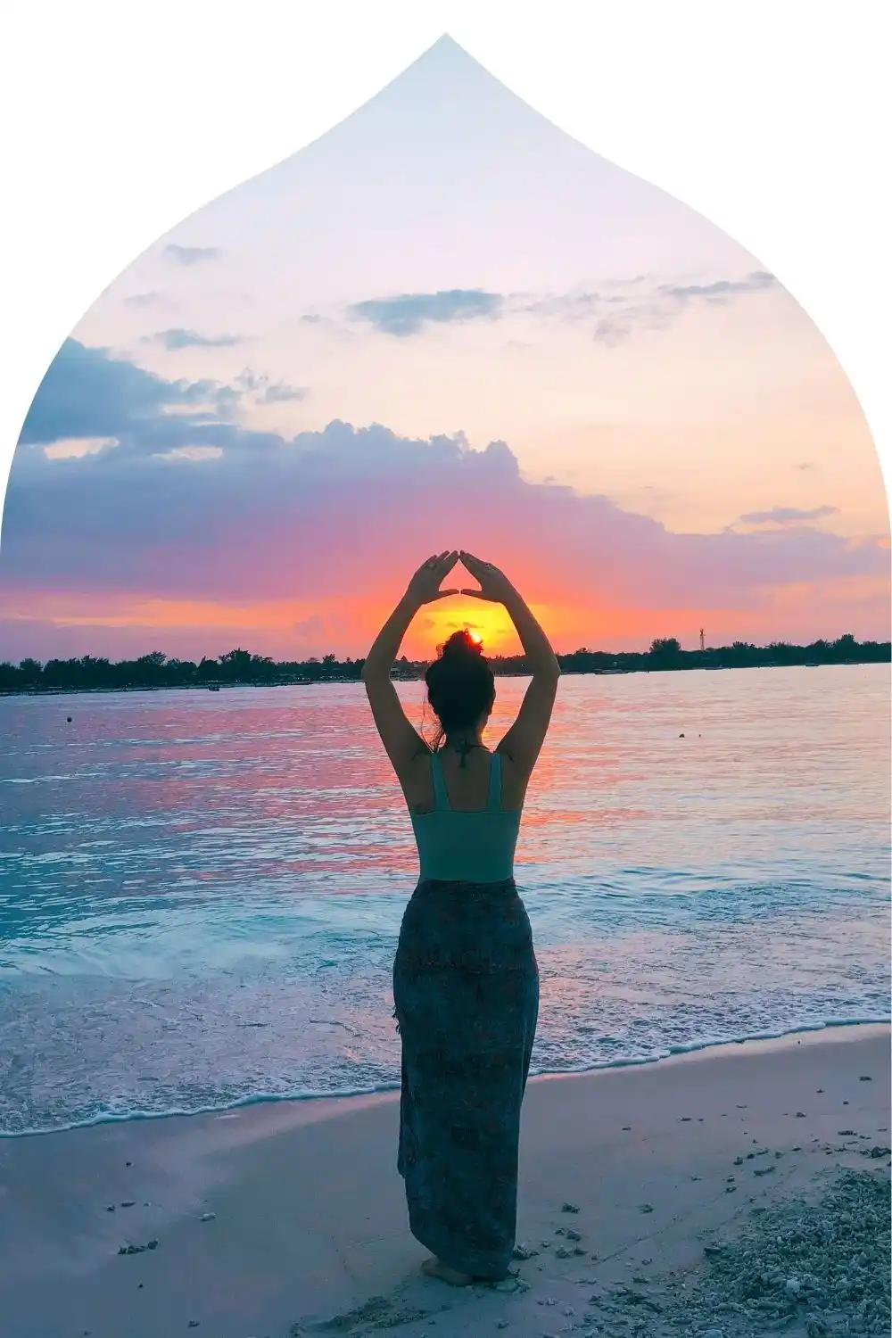 Psychic Carla holding triangle arms pose at sunset, symbolizing astrology, natal charts, and connection with The Blue Team