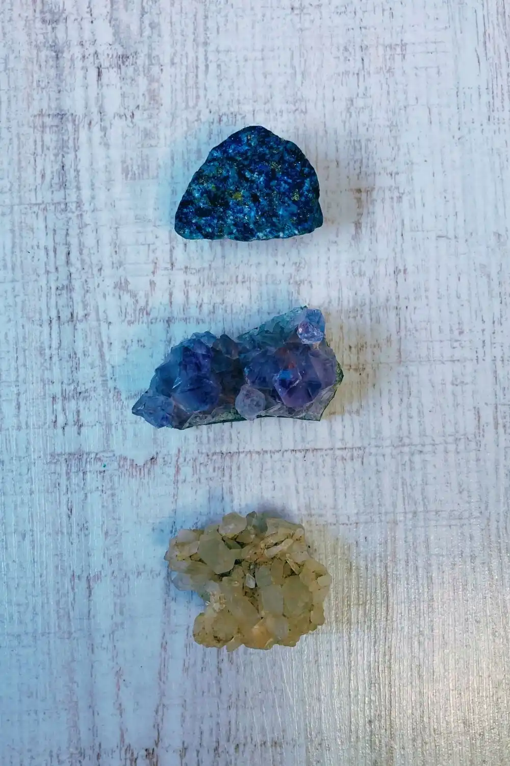 Blue, purple, and yellow healing crystals used in psychic astrology and natal chart readings for energy balance
