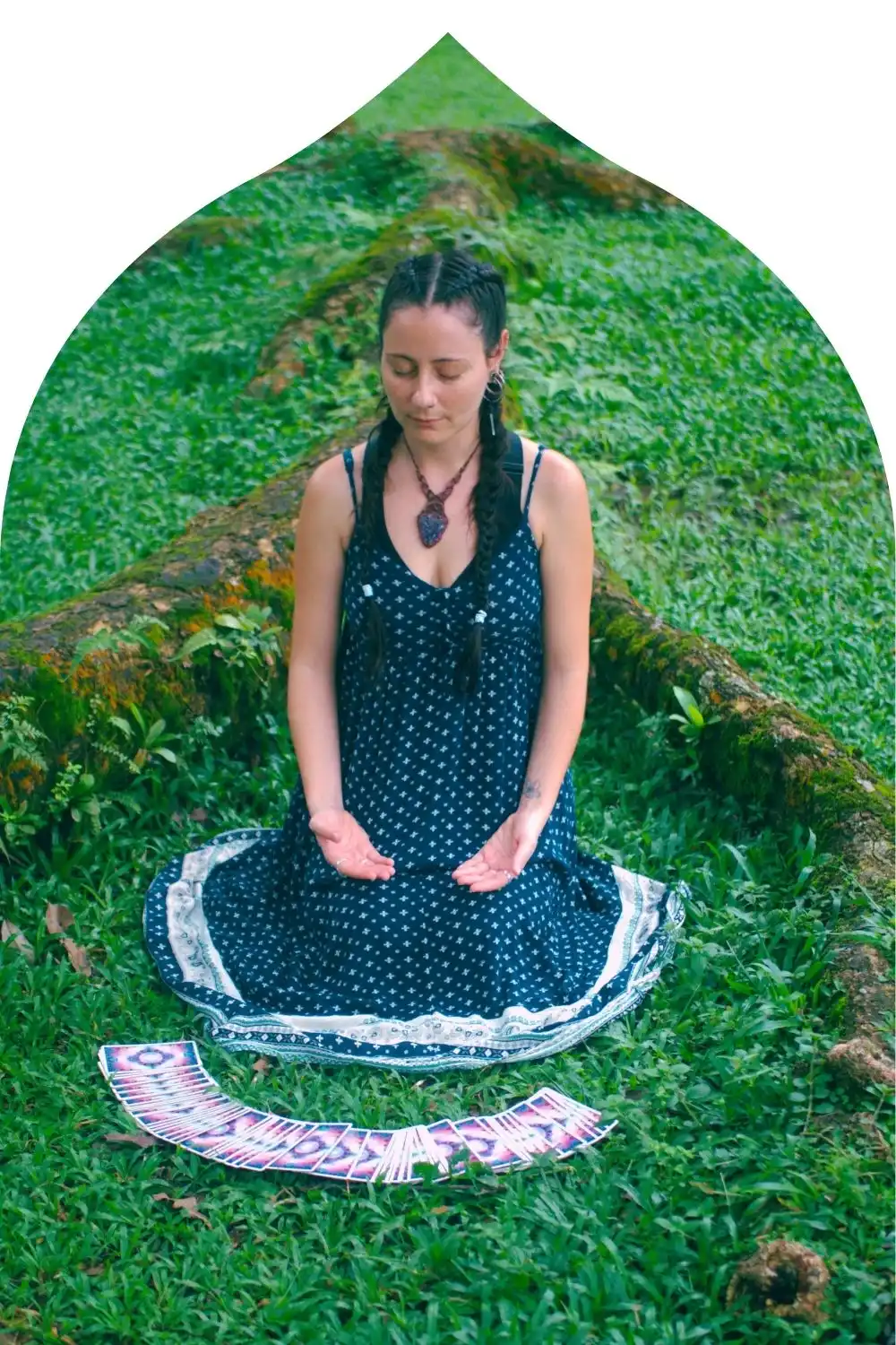 Carla, psychic reader at LunAscention, sitting in meditation with tarot cards for intuitive guidance.