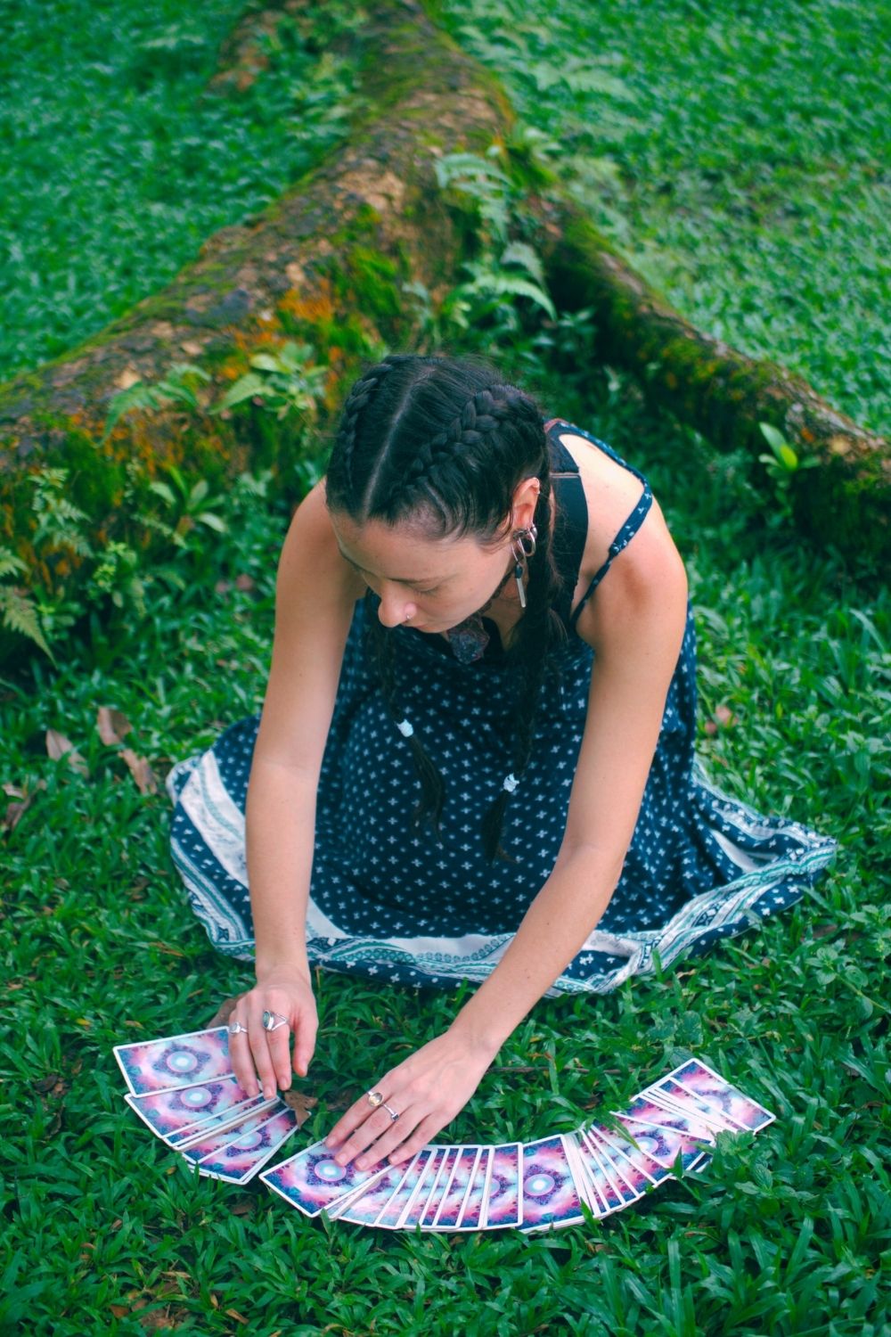 Carla from LunAscention spreading tarot cards in nature during a psychic reading session.