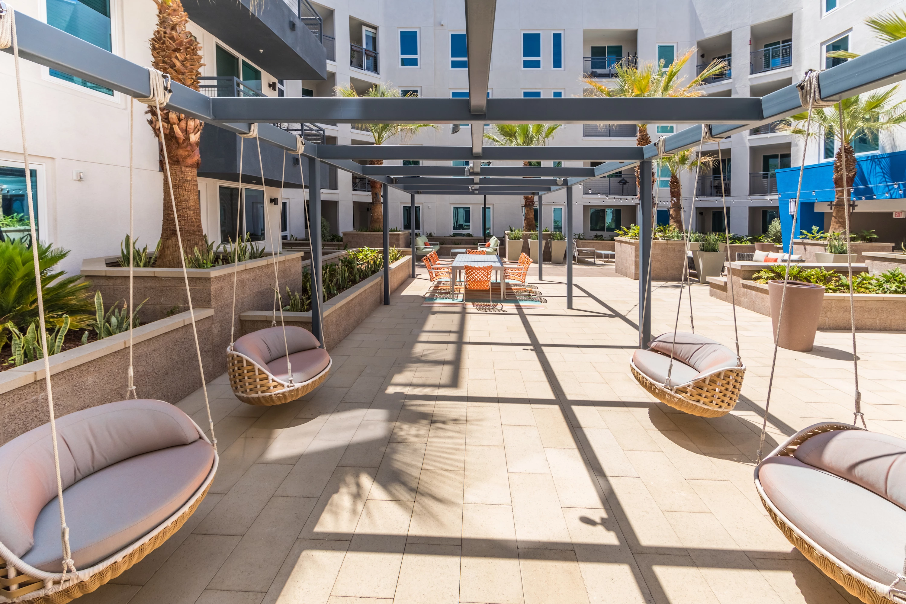 1241-13-exterior-courtyard-swing-seating-at-vela-on-ox-apartments-in-woodland-hills-c.jpg