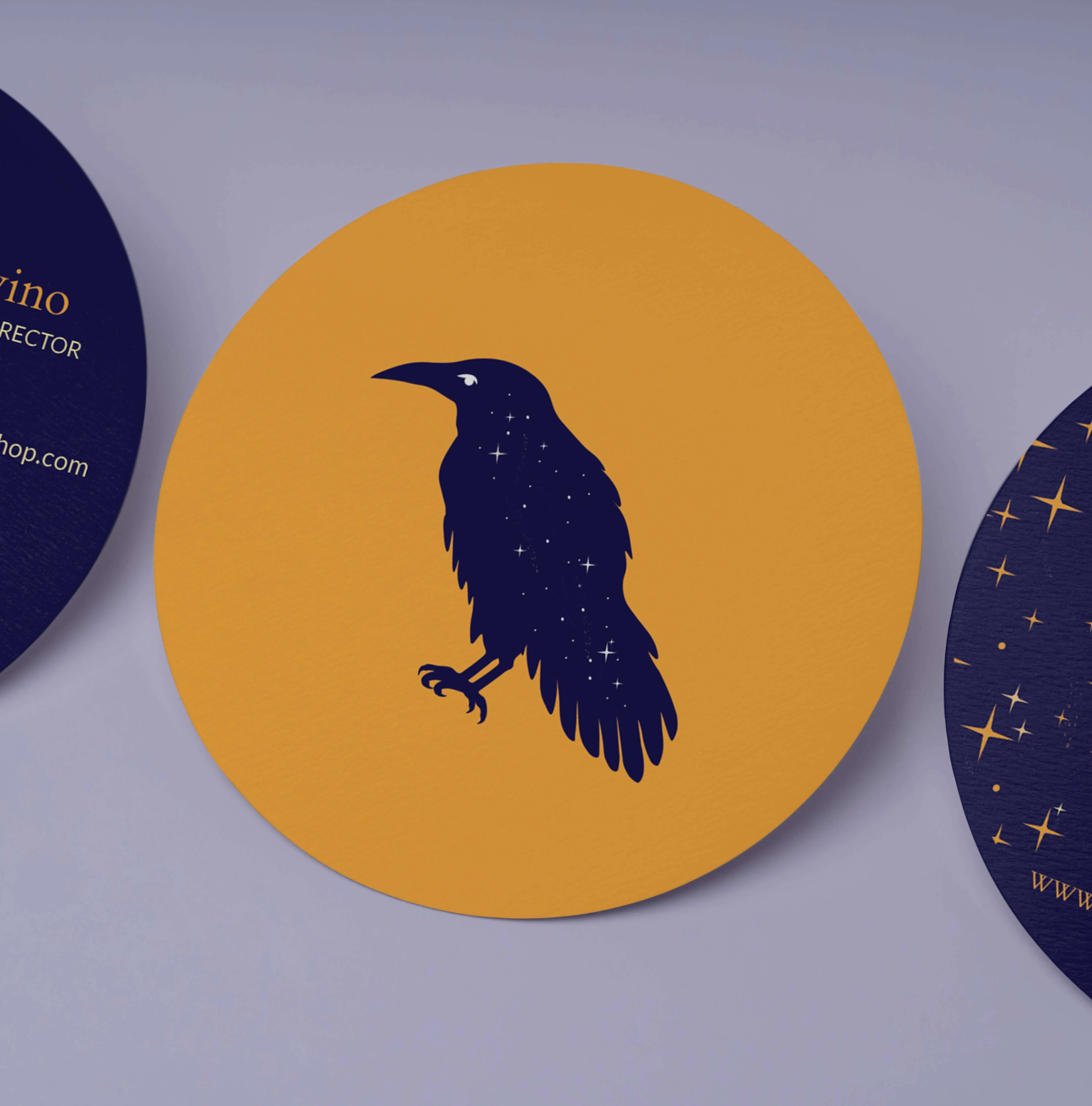 circle bussiness card with blue raven on it for Corvus BookShop