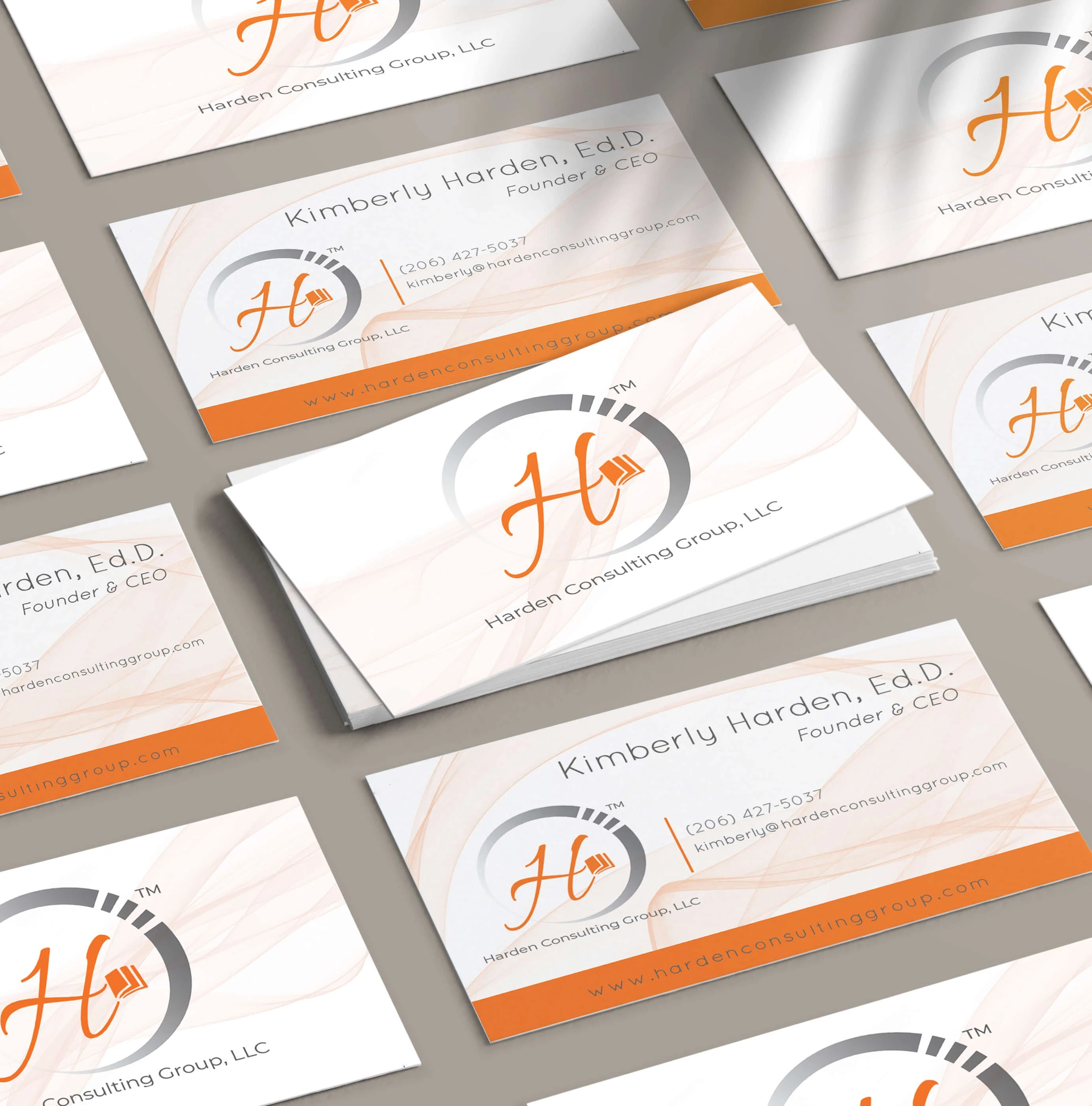 orange business cards with H logo of Harden Consulting Group