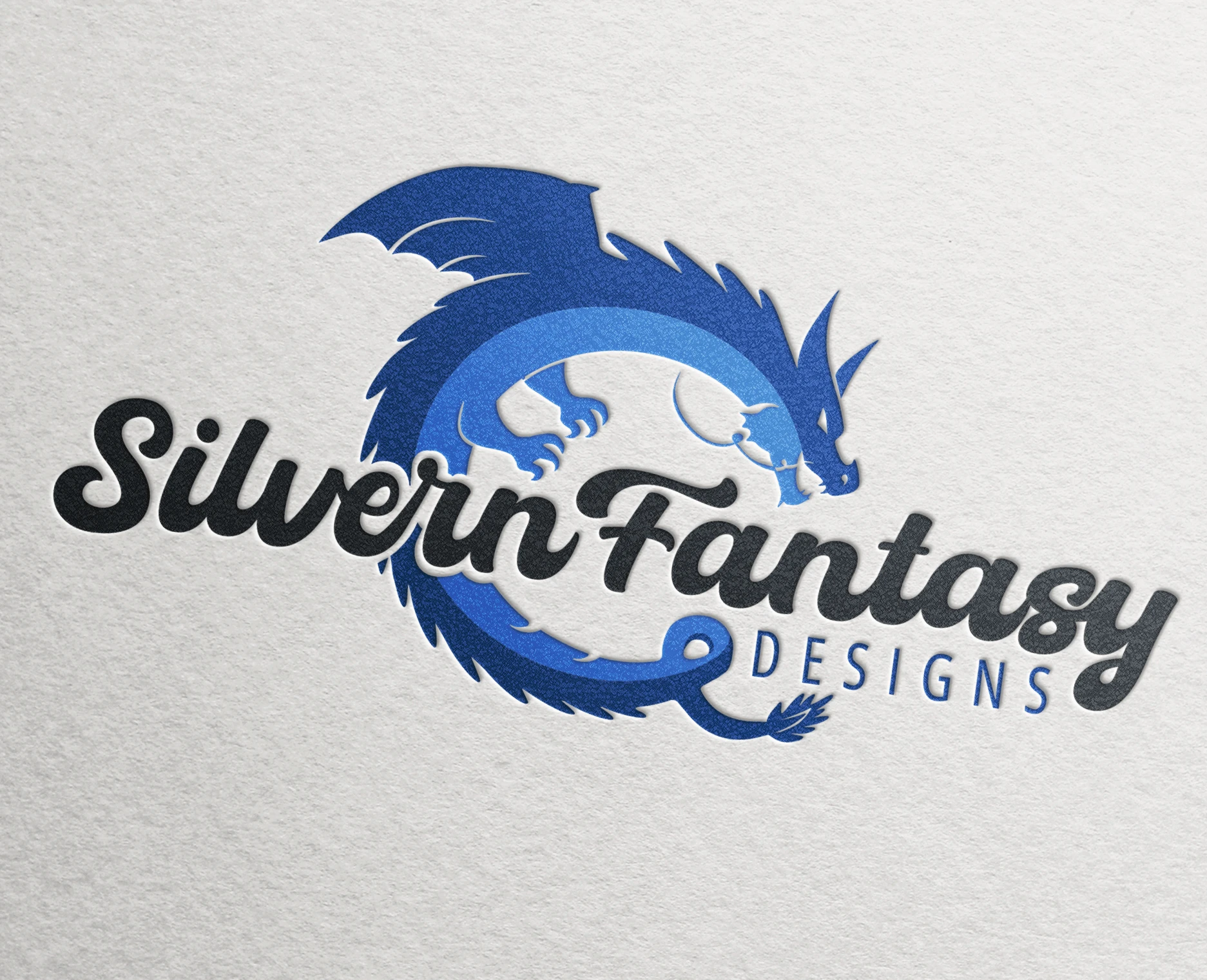a blue dragon logo of Silvern Fantasy Designs company