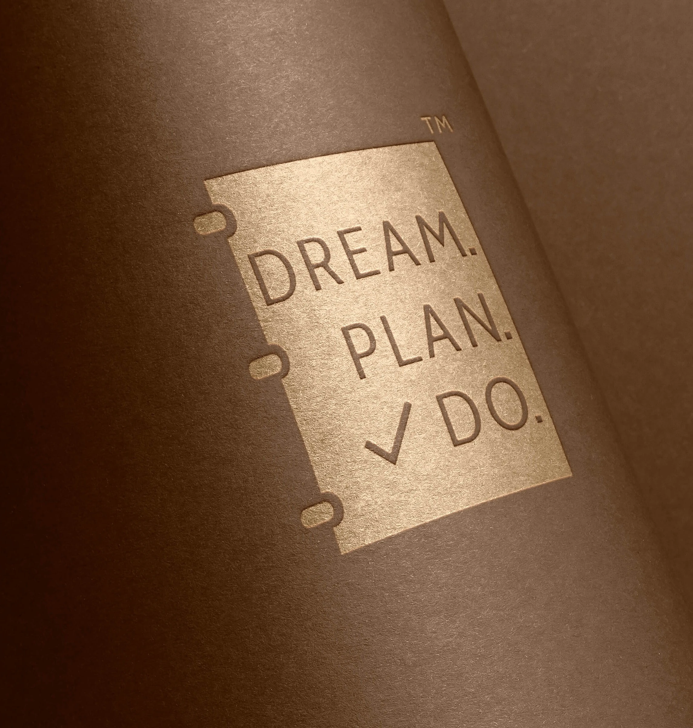 An agenda with the words Dream.Plan.Do  to make them in a logo and being display as logo